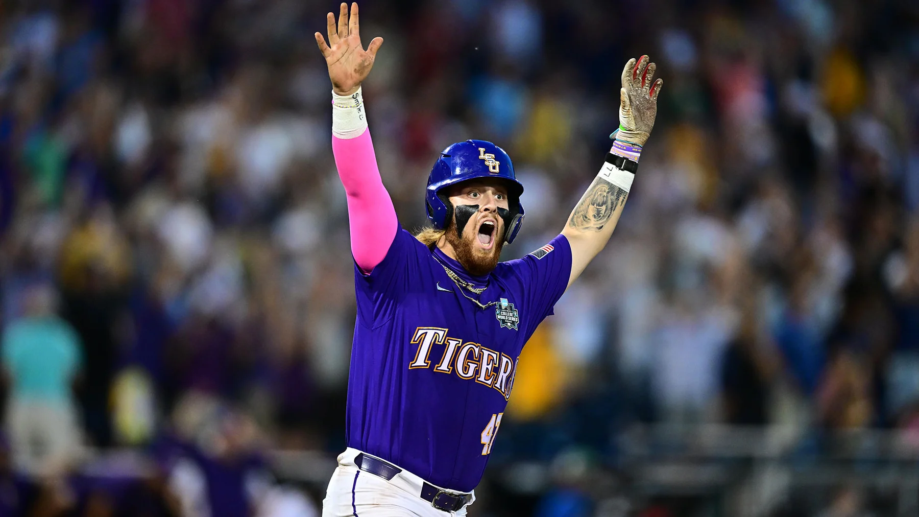 LSU hitter Tommy White celebrating with both arms raised